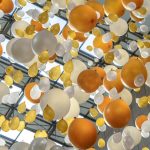 Vibrant arrangement of orange, white, and yellow balloons hanging in an indoor celebration space.